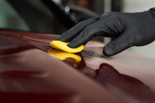 Clay bar treatment during a wash and wax service in fort worth